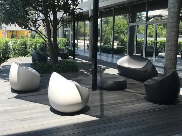 Shaded outdoor seating on the deck at the building entrance