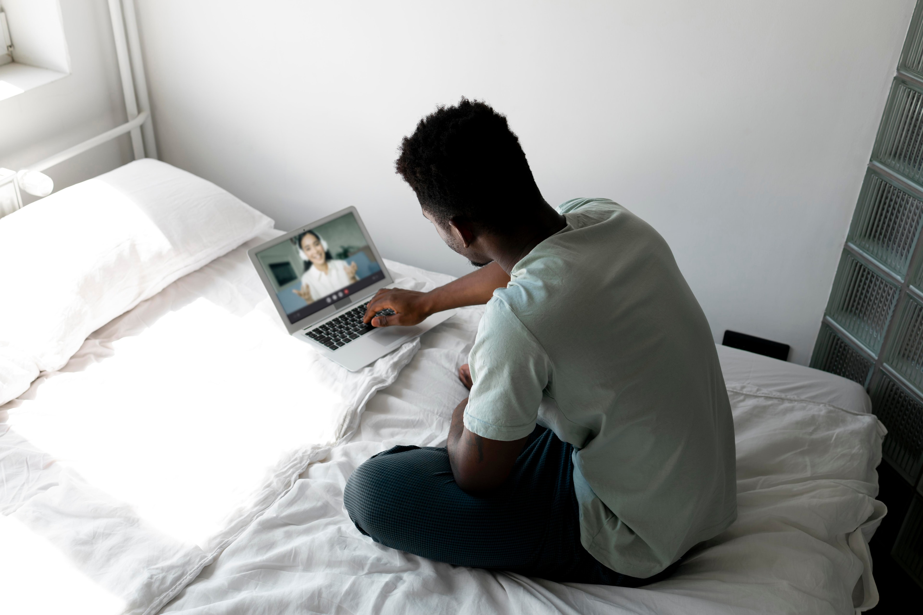 Person attending a virtual individual therapy session on a laptop